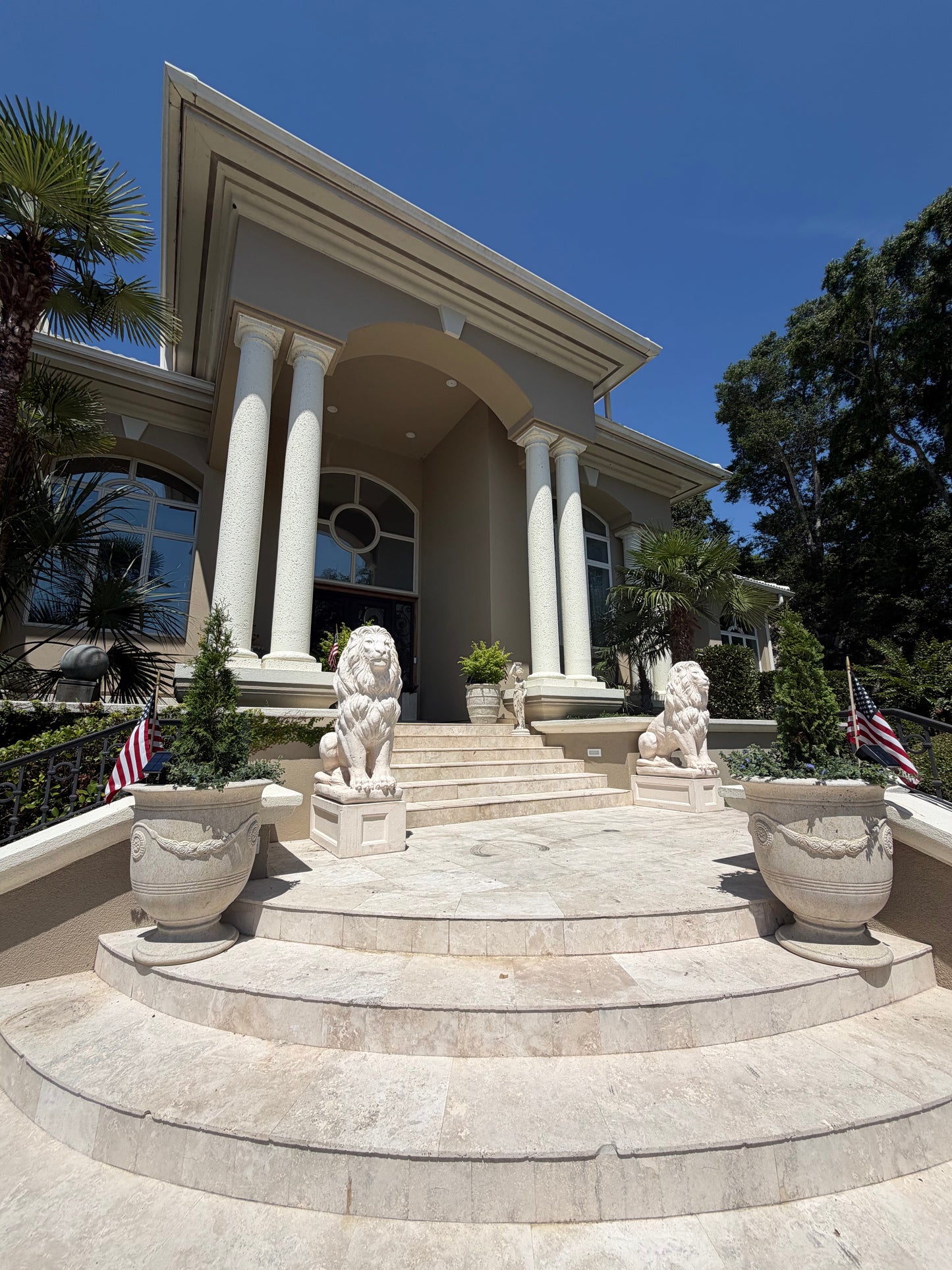 Pair of concrete lion statues flanking home entrance