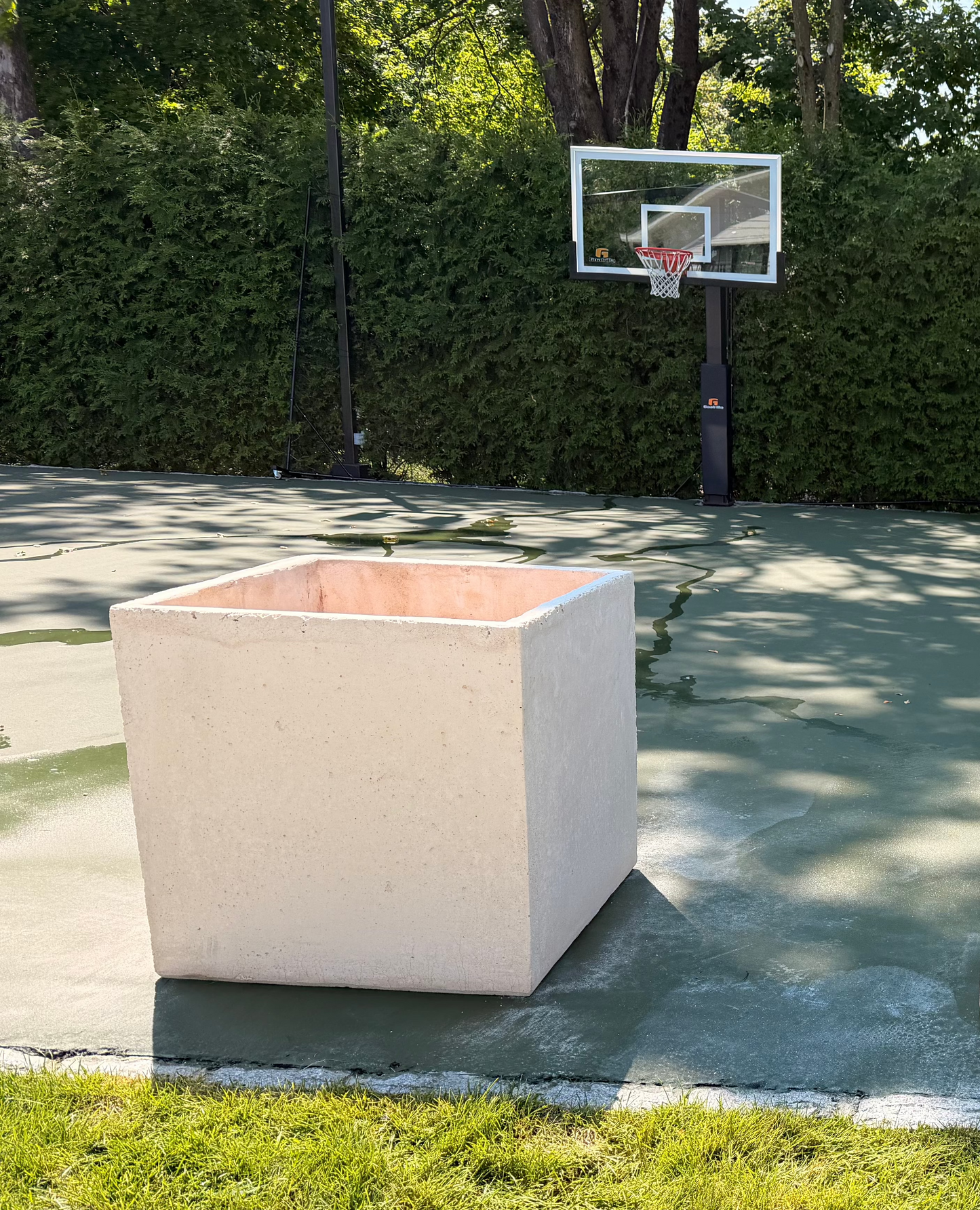 Our large square concrete planter. This customer placed several between his basketball court & pool to enhance the perimeter.
