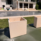 Large concrete square planters used to perimeter this home's basketball court and  pool