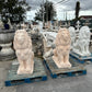 Group of beige concrete lion statues lined up for shipping to Texas