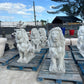 Group of white concrete lion statues lined up for large commercial fulfillment