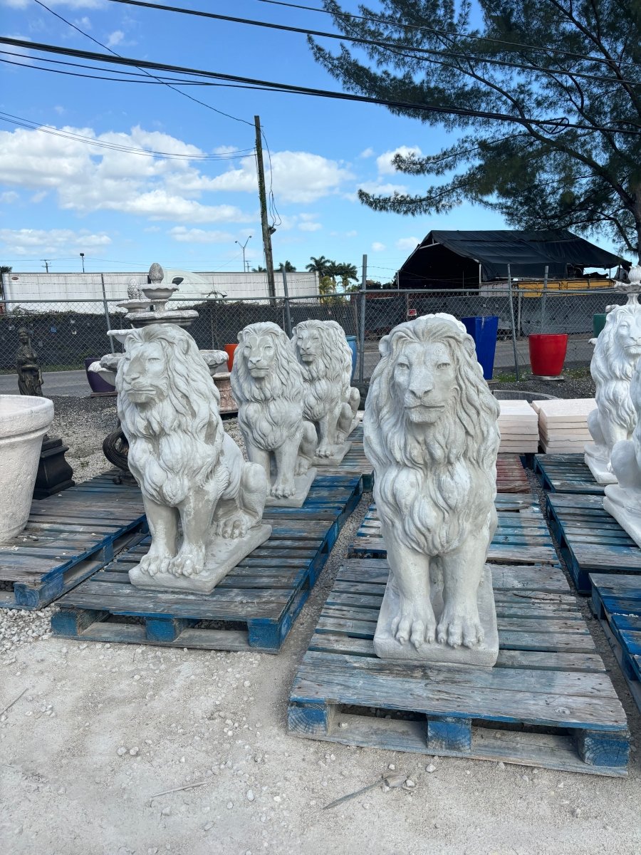 Group of white concrete lion statues lined up for large commercial fulfillment
