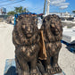 Pair of large bronze concrete lion statues on pallet ready for shipment