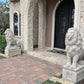 Pair of Gray concrete lion statues on square pedestal at entrance of estate shipped to Houston, Texas
