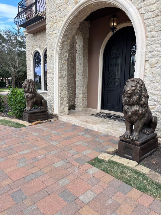 Pair of large bronze concrete lion statues at estate driveway entrance showing optional pedestals