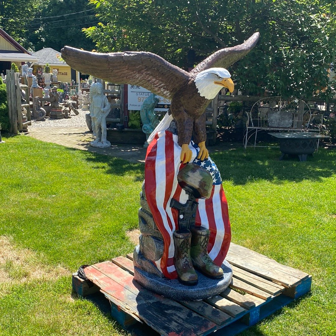 Military boots helmet and American flag detail — concrete patriotic eagle statue