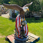 Large concrete patriotic bald eagle statue with American flag and military boots — outdoor garden sculpture